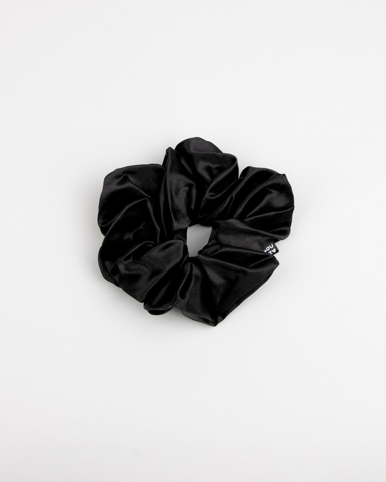 Large black scrunchie on a white background