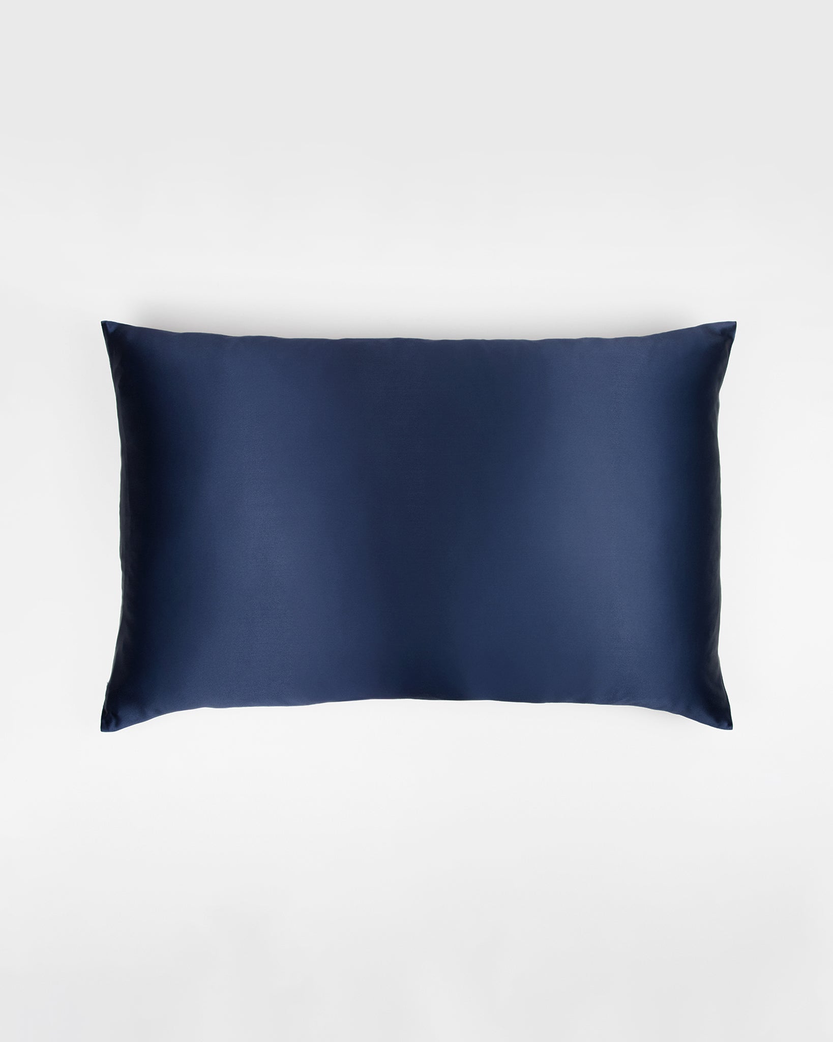Navy blue silk pillowcase on a white background