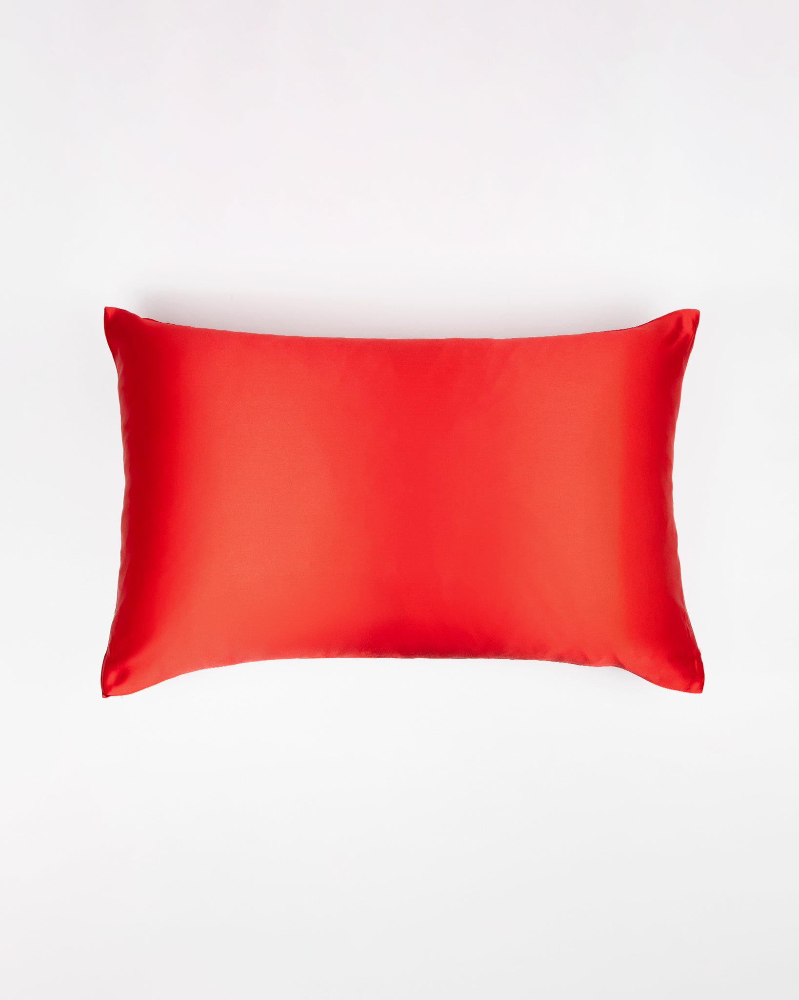 Red silk pillow on a white background