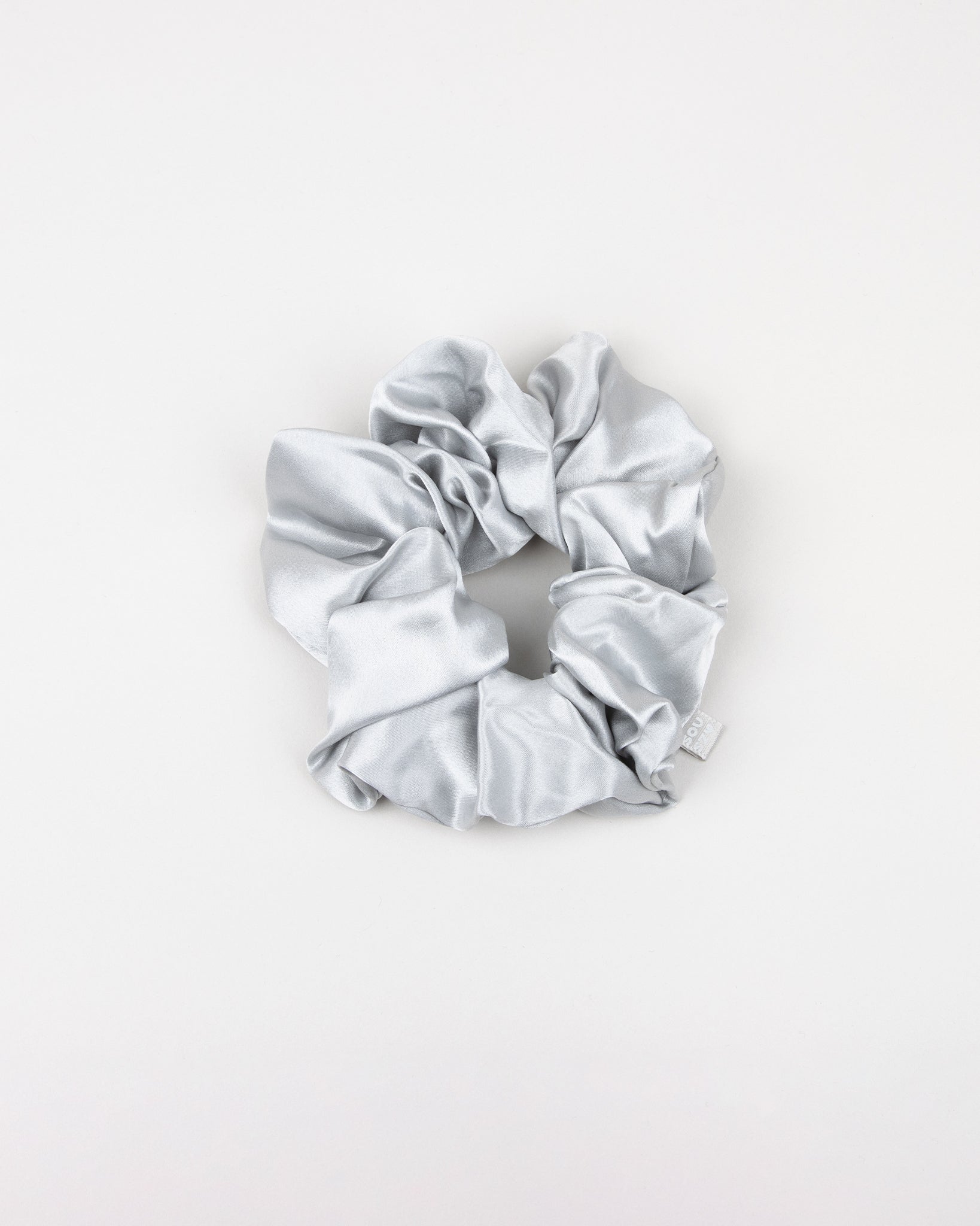 Large gray silk scrunchie on a white background